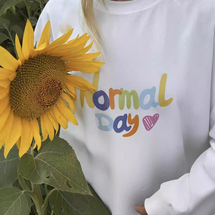 Damen lässiges Langarmshirt mit buntem Schriftzug Drune